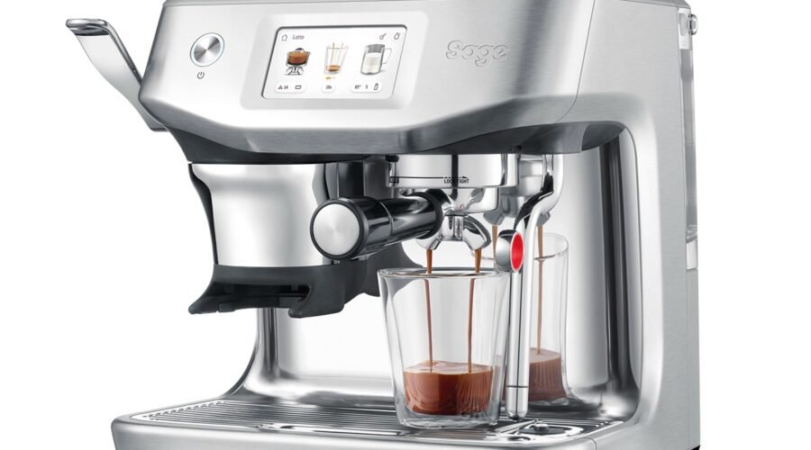 a silver espresso machine with a glass of liquid bean to cup coffee machine