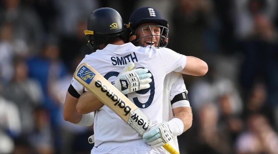 two men Joe Root and Smith wearing sports uniforms hugging