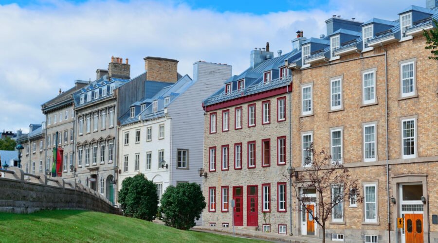 a row of buildings with grass and trees, House Prices Crash